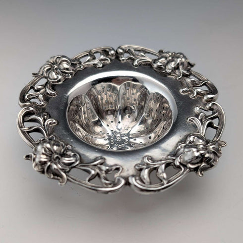 Antique American sterling silver tea strainer with floral decoration