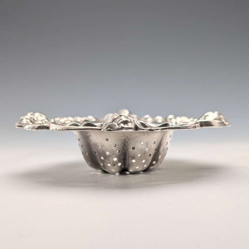 Antique American sterling silver tea strainer with floral decoration