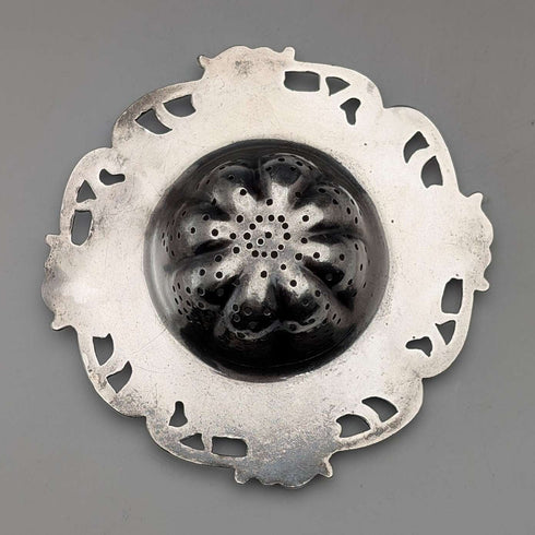 Antique American sterling silver tea strainer with floral decoration