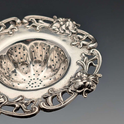 Antique American sterling silver tea strainer with floral decoration