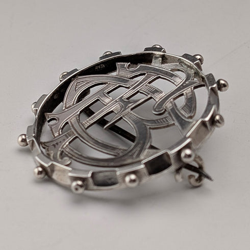 Antique sterling silver monogrammed round brooch
